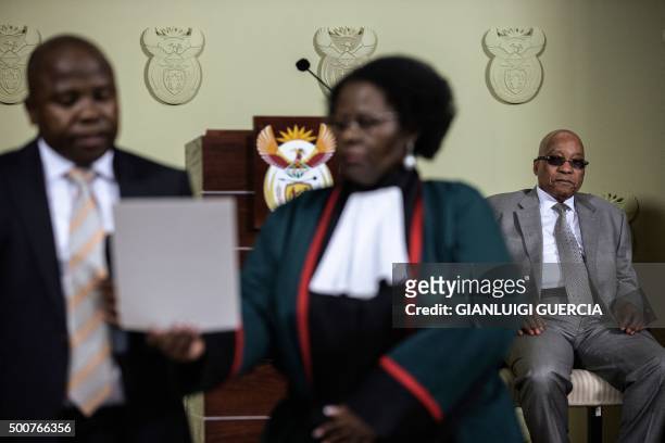 South African president Jacob Zuma looks on as David Van Rooyen is sworn in by Justice minister Sisi Khampepe as new South African Minister of...