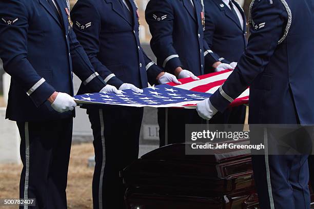 soldiers folding flag at military funeral - police funeral stock pictures, royalty-free photos & images