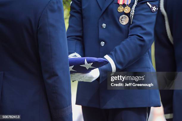 soldiers folding flag at military funeral - military ceremony stock pictures, royalty-free photos & images