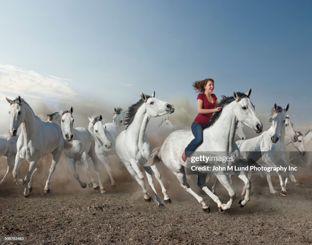 Mixed Riding Mixed Race Woman Riding Wild Horse In Desert High-Res Stock Photo ...
