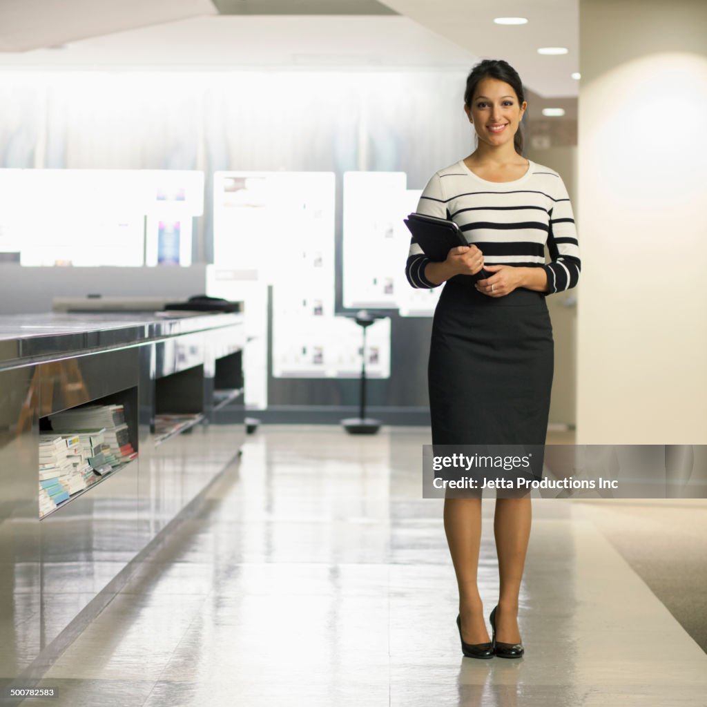 Mixed race businesswoman smiling in office