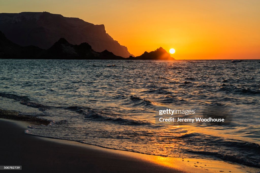 Sun setting over rocky coastline, Qalansyia, Socotra, Yemen