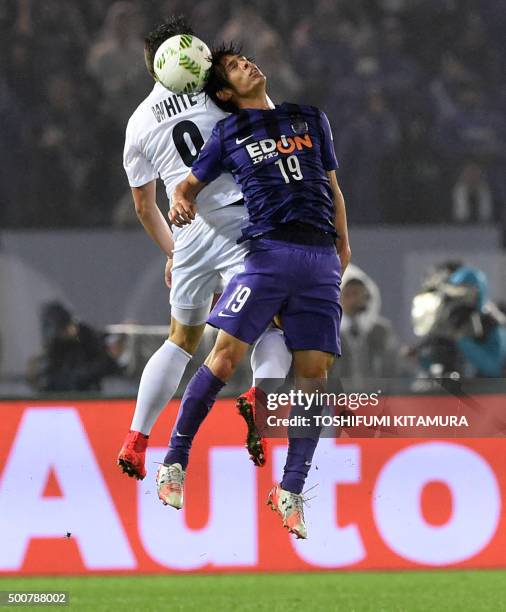 Sanfrecce Hiroshima defender Sho Sasaki fights for the ball with Auckland City FC midfielder Darren White during their FIFA Club World Cup football...