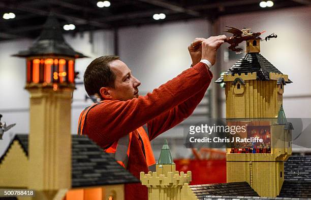 Lego builder Eric Philhan places a dragon on top of Hogwarts School, from the Harry Potter series, made out of 250,000 bricks over 800 hours at ExCel...