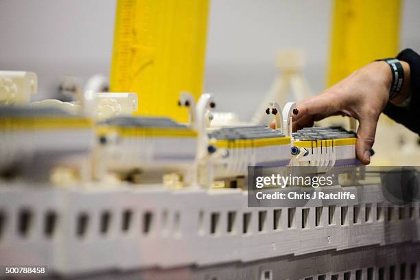 Lego builder Annie Diment puts the lifeboats on their Lego Titanic, made of 120,000 bricks over 3 months at ExCel on December 10, 2015 in London,...