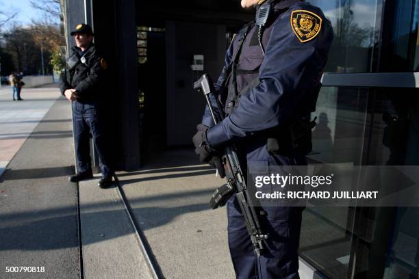 Security forces stand guard at the entrance of the United Nations headquarter in Geneva on December 10, 2015 after Swiss police declared actively...