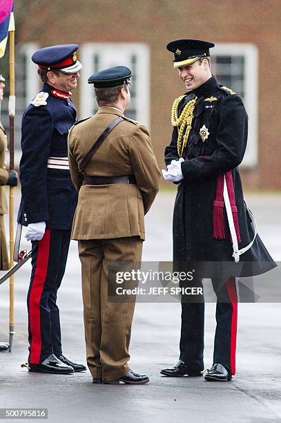 Britain's Prince William, Duke of Cambridge, talks to officers as he visits to present the Government Ebola Medal for Service in West Africa during...