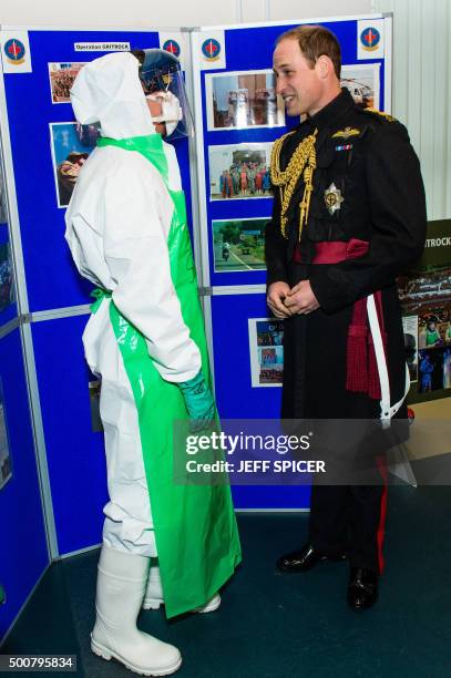 Britain's Prince William, Duke of Cambridge talks to a British Army medic demonstrating protective clothing equipment at Keogh Barracks in Aldershot,...