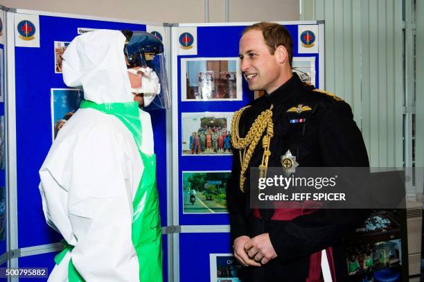Britain's Prince William, Duke of Cambridge talks to a British Army medic demonstrating protective clothing equipment at Keogh Barracks in Aldershot,...