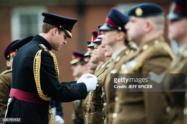 Britain's Prince William, Duke of Cambridge, presents the Government Ebola Medal for Service in West Africa during the 2014/15 Ebola outbreak to...