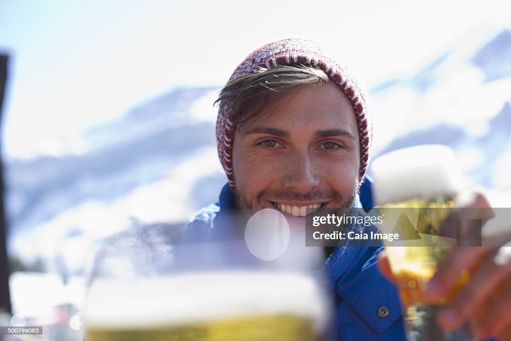 Portrait of man drinking beer outdoors