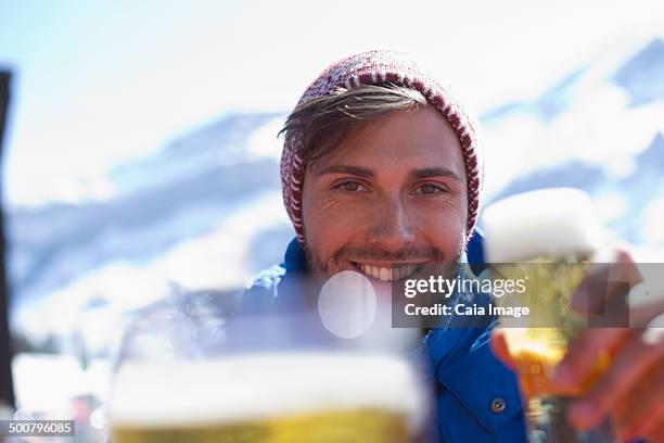 portrait of man drinking beer outdoors - ski closeup stock-fotos und bilder