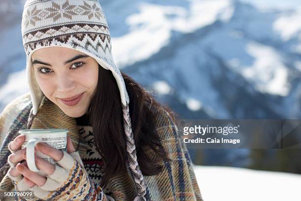 portrait of woman drinking hot cocoa in snow - hot filipina women stock pictures, royalty-free photos & images