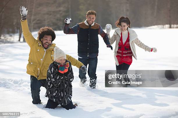 friends enjoying snowball fight - run hide fight stock pictures, royalty-free photos & images