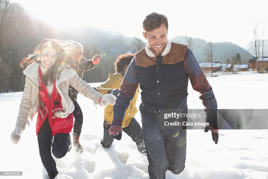 Friends running in snow