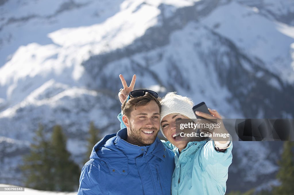 Couple taking selfie in snow