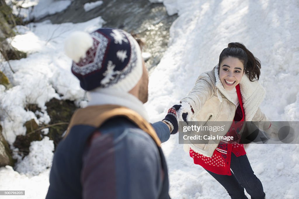 Couple holding hands in snow