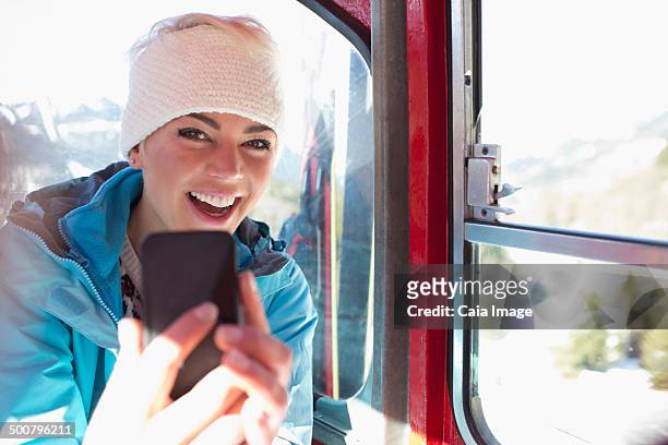 portrait of smiling woman taking selfie in ski lift - woman on ski lift stock pictures, royalty-free photos & images