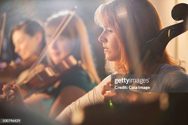 cellist performing - klassisches konzert stock-fotos und bilder