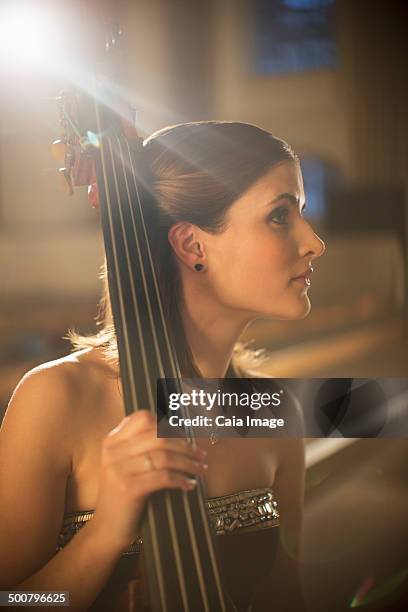 double bassist looking away - female double bass player stock pictures, royalty-free photos & images