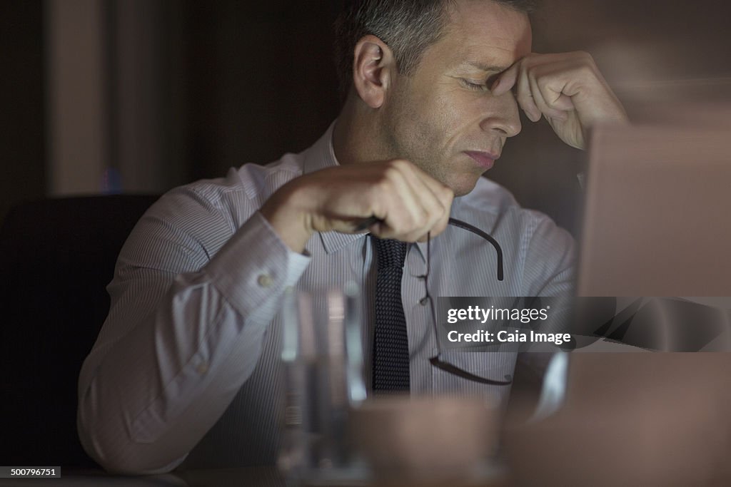 Tired businessman in office at night
