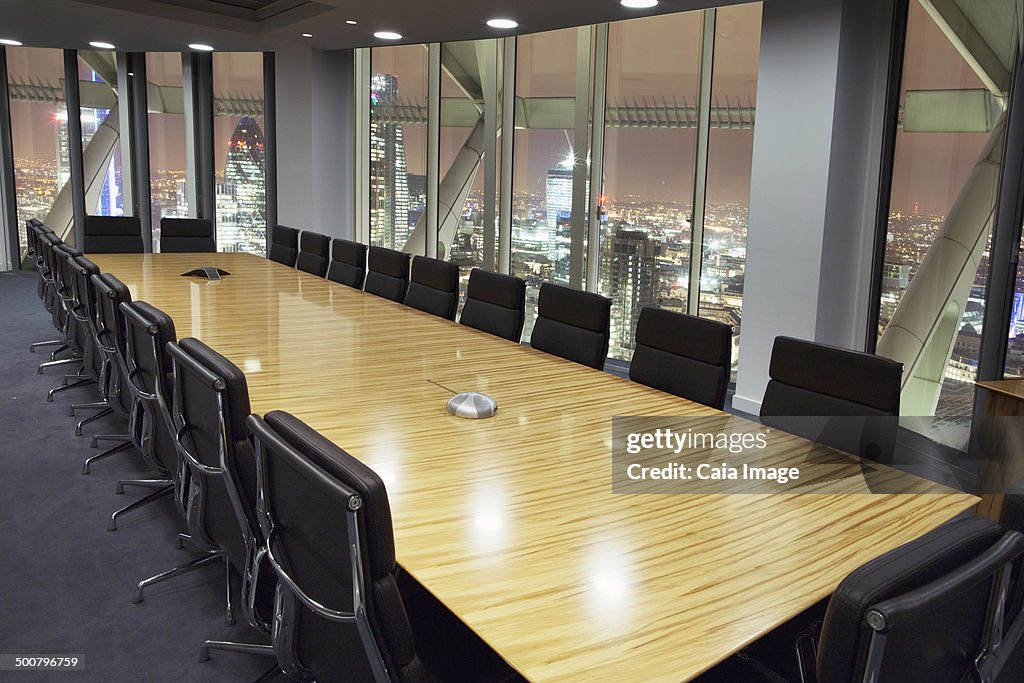 Empty conference room overlooking London at night, London, United Kingdom