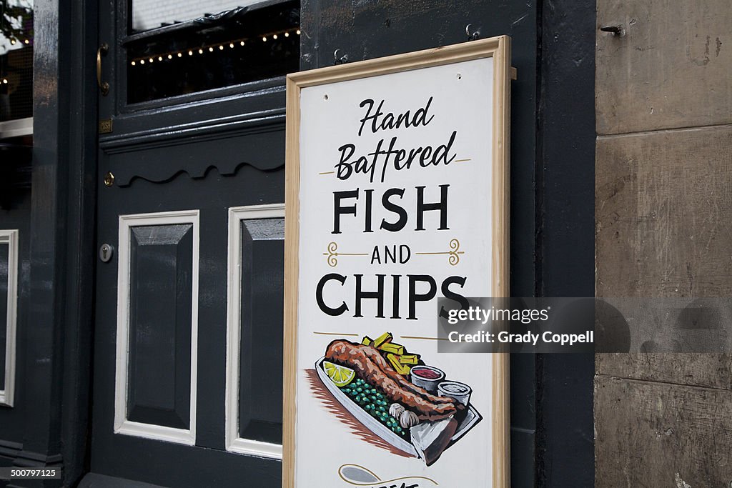 Fish and chips sign outside pub