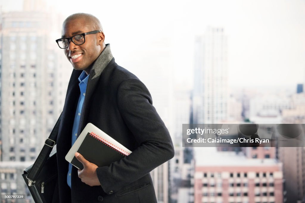 Portrait of businessman in urban window