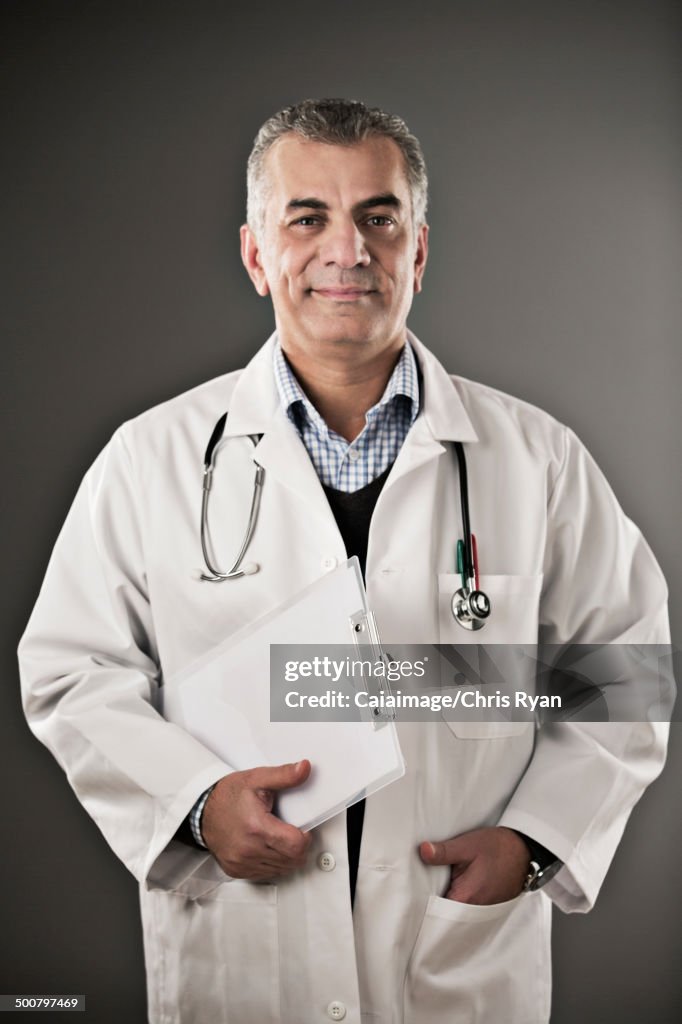 Portrait of confident doctor with clipboard