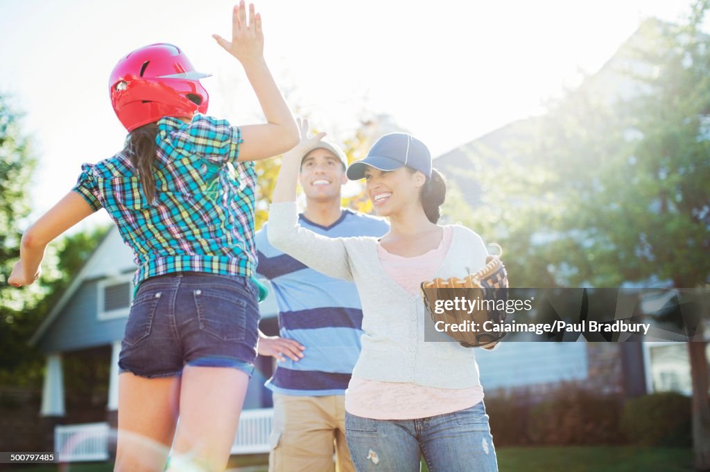 Family playing baseball