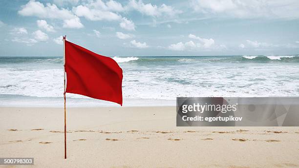 red flag on beach - flag imagens e fotografias de stock