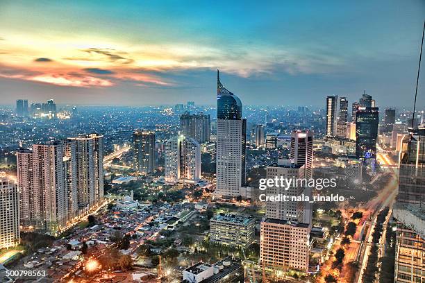 city skyline at sunset, jakarta, indonesia - indonesia stock-fotos und bilder