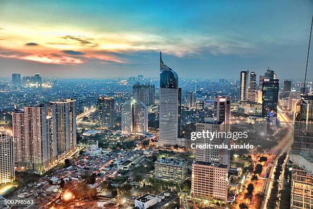 city skyline at sunset, jakarta, indonesia - indonesio fotografías e imágenes de stock