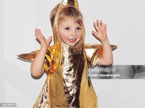 boy in fancy dress gold star costume - maschere di carnevale foto e immagini stock