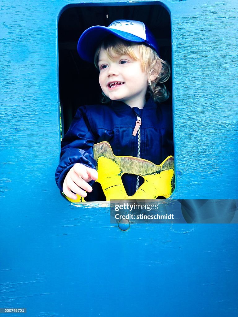 Boy playing on ship in the playground