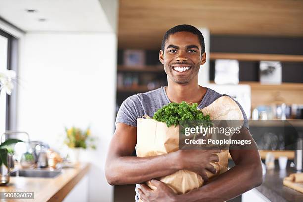 i'm ready to impress my lady tonight - young man groceries kitchen stock pictures, royalty-free photos & images