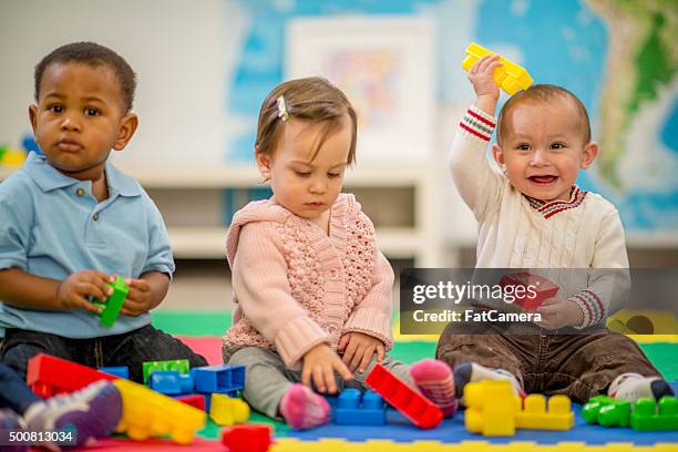children playing with blocks - baby blocks stock pictures, royalty-free photos & images