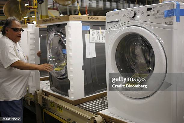 Worker assembles front loading machines at the Whirlpool Corp. Manufacturing facility in Clyde, Ohio, U.S., on Wednesday, Dec. 9, 2015. The U.S....