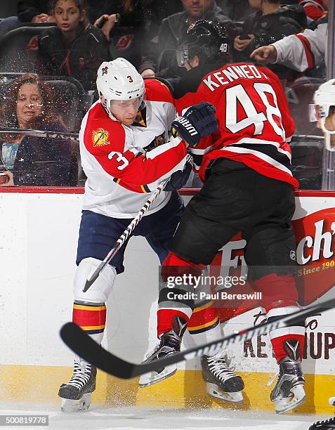 Steven Kampfer of the Florida Panthers throws a check in an NHL hockey game against the New Jersey Devils at Prudential Center on December 6, 2015 in...