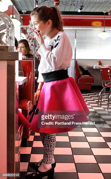 Dressed in a poodle skirt, Addison Macavian laughs while talking with a friend at the Blast From the Past diner in Waterboro on Wednesday, December...