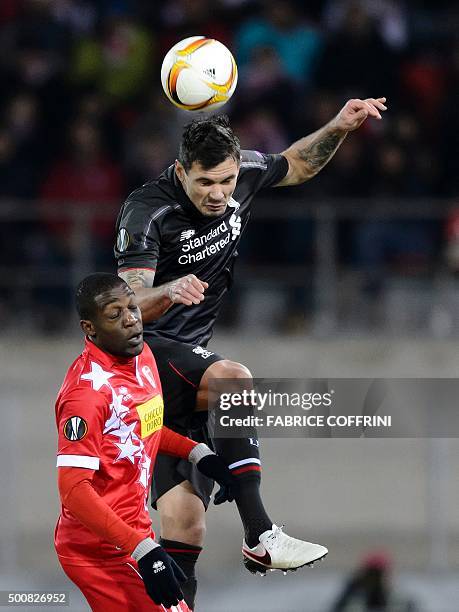 Liverpool's Brazilian midfielder Philippe Coutinho heads the ball behind Sion's Belgian midfielder Geoffrey Bia during the UEFA Europa League group B...