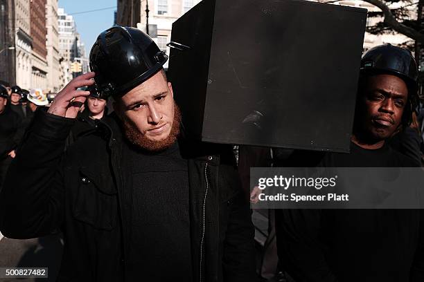Construction workers carry empty caskets representing workers killed on a construction site during a rally in lower Manhattan to demand a safer...