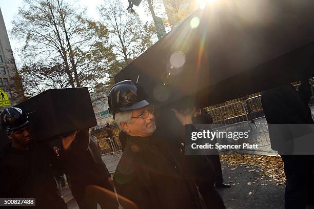 Construction workers carry empty caskets representing workers killed on a construction site during a rally in lower Manhattan to demand a safer...
