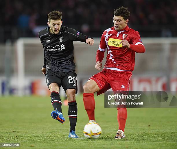 Adam Lallana of Liverpool competes with Veroljub Salati of FC Sion during the UEFA Europa League match between FC Sion and Liverpool FC at Estadio...