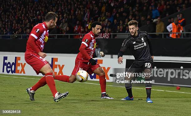 Adam Lallana of Liverpool competes with Carlitos of FC Sion during the UEFA Europa League match between FC Sion and Liverpool FC at Estadio...