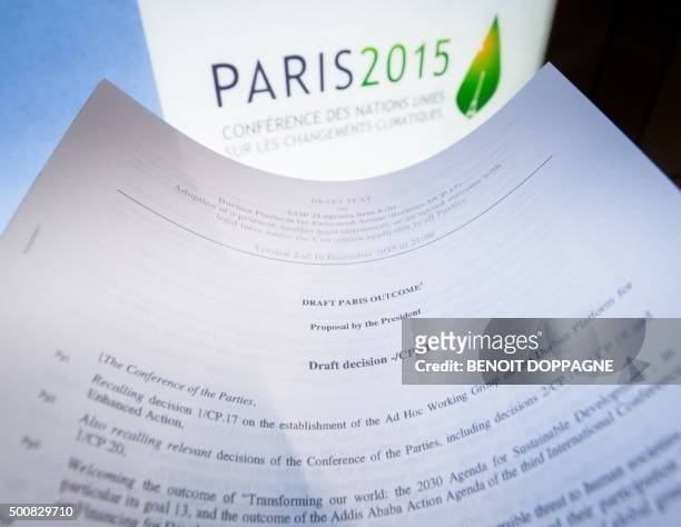 An illustration picture taken on December 10, 2015 in Paris shows a draft for the outcome of the COP21 United Nations conference on climate change...