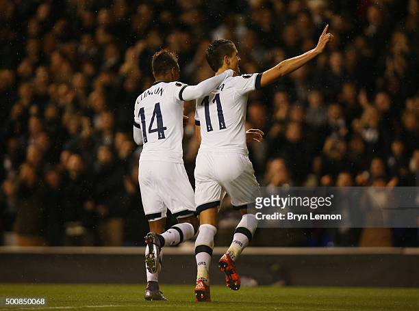Erik Lamela of Spurs is congratulated by teammate Clinton N'jie of Spurs after scoring his team's third goal and completing his hat trick during the...