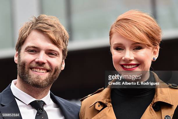 Actors Seth Gabel and Bryce Dallas Howard attend a ceremony honoring Ron Howard with the 2,568th Star on The Hollywood Walk of Fame on December 10,...