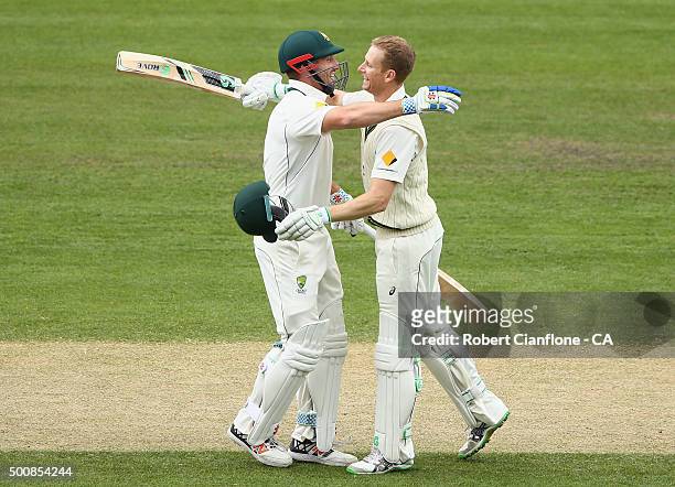 Adam Voges of Australia celebrates with Shaun Marsh after reaching his double century during day two of the First Test match between Australia and...