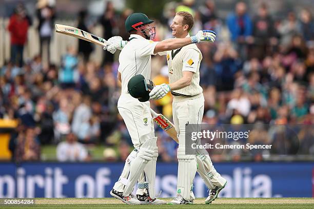 Adam Voges of Australia celebrates scoring 200 runs with team mate Shaun Marsh of Australia during day two of the First Test match between Australia...